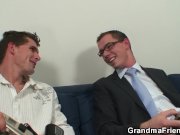 Busty mommy swallows two cocks 1/16