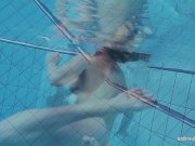 Redheaded Katrin is stripping underwater 16/16