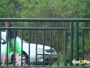 Pee Desperation - Redhead fires piss streams through a railing in public 15/16