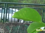 Pee Desperation - Redhead fires piss streams through a railing in public 2/16