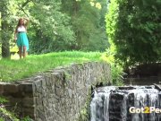 Sexy babe pees near a waterfall 2/16