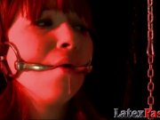 Latex domina erotically torments submissive chick with toys 1/16